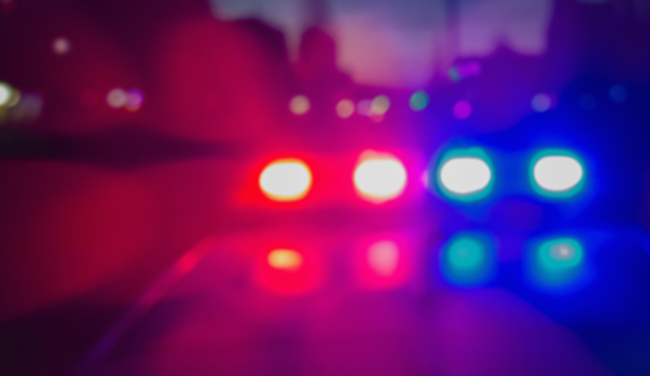Lights of police car in night time. Night patrolling the city, lights flashing. Abstract blurry image.