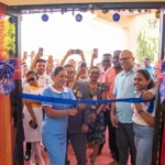 Minister of Health, Dr Frank Anthony and a trainee nurse cuts the ribbon to commission the new administrative building_training centre