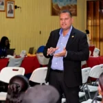 Minister of Housing and Water Collin Croal speaking at the housing outreach in Linden