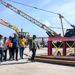 Minister of Public Works Bishop Juan Edghill alongside engineers inspecting the Bartica Stelling