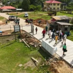 Minister of Public Works Bishop Juan Edghill inspects road works in Port Kaituma, Region One