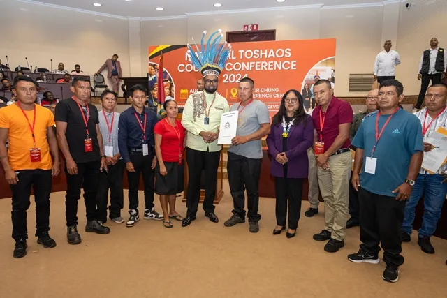 The village of Karasabai in Region Nine also received their COT last year. In this picture, Toshao, David Albert, is seen receiving his village’s certificate of title