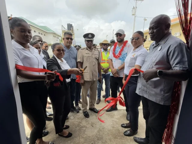 Minister of Home Affairs and Members of the Region Three Police Force cutting the ribbon for the new command centre